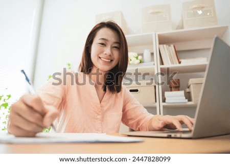 Photo of young Asian businesswoman working