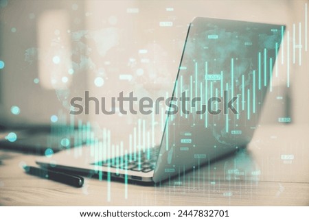 Close up of laptop and supplies with growing blue forex chart and map hologram on blurry background. Banking, invest and financial growth concept. Double exposure