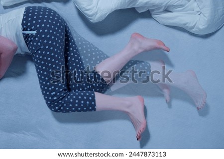 Woman With RLS - Restless Legs Syndrome. Sleeping In Bed Royalty-Free Stock Photo #2447873113