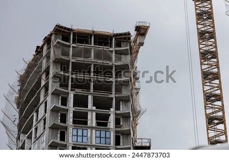 New complex building under construction against gray sky Royalty-Free Stock Photo #2447873703