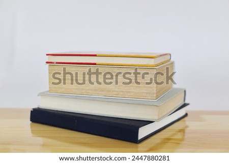 stack of books on wooden table in library, education, book