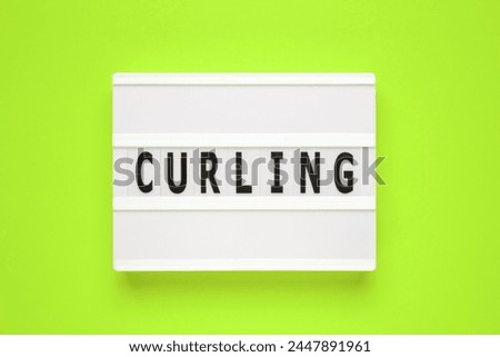 The word curling on lightbox isolated green background. Type of winter sports game.