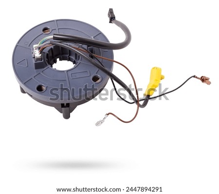 Steering angle sensor disassembled on a white isolated background, spare part for car repair or for sale at junk yard.