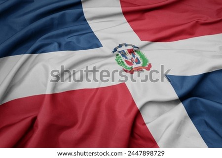waving colorful national flag of dominican republic. macro shot