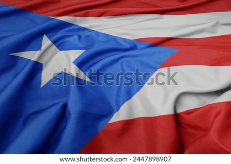 waving colorful national flag of puerto rico. macro shot