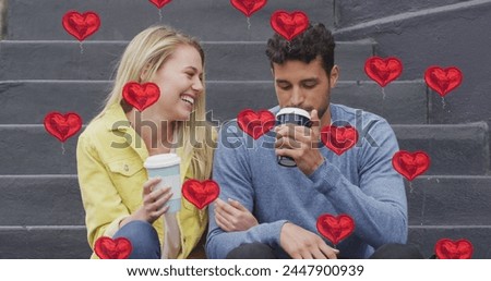Image of heart icons floating over happy caucasian couple talking and drinking takeaway coffee. social media and communication interface concept digitally generated image.