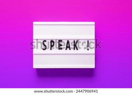 A rectangular light box featuring the word speak in a vibrant font, set against a background blending shades of purple, pink, and electric blue. Perfect for branding and graphic design purposes