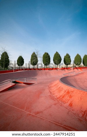Empty public pink skate park waiting for skaters. Skateboard in city. Skate and Bike Park. Extreme sports ground
