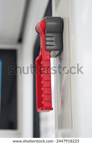 Safety Hammer in a bus and Glass breakage, Royalty-Free Stock Photo #2447918225