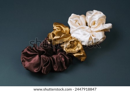 Three Colored Scrunchies on Black Background