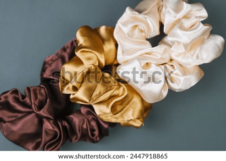 Close up of silk Scrunchies in Various Colors on Gray Background