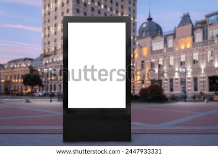 Blank City Format (CityLight, Lightposter) Billboard Pylon on. Urban Evening in Public Place. European city square on Blurred Background. Mock-up with Copy Space for Marketing and Advertising. 