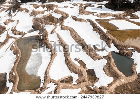 Drone photo: Rice terraces with melting snow