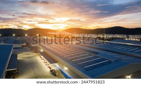 Top view Solar Panels on Warehouse Factory. Solar photo voltaic panels system power or Solar Cell on industrial building roof for producing green ecological electricity. Production of renewable 