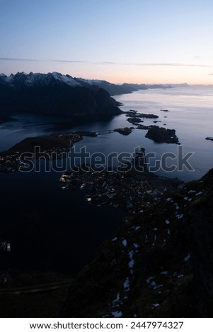 Views from top of Reinebringen mountain hike in Lofoten, Norway.  Snow covered mountains captured at sunset by a mirrorless camera.  Located far North in the Arctic Circle.  A famous Lofoten hike.