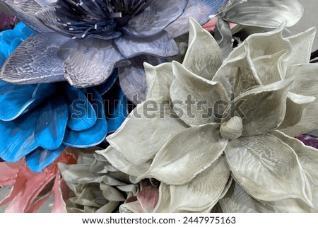 Decorative artificial grey flower made of fabric. Grey blue exotic plant with large petals. Vintage floral card.Template business cards, phone case, covers, packaging, interior decoration