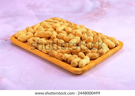 Wooden Tray Overflowing with Peanuts