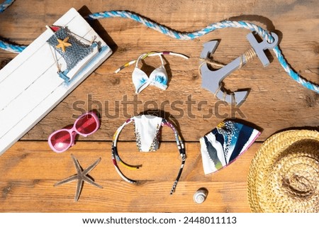 summer straw hat, sunglasses, sea anchor, starfish on old wooden table, traveling with children to sea, Childhood activity for enjoyment and recreation, being relaxed and free from stress