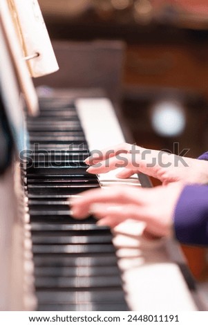 fingers close up playing piano music, copy space background image, authentic old dusty piano