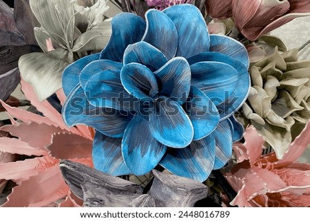 Decorative artificial blue flower made of fabric. Beige pink exotic plant with large petals. Vintage floral card.Template business cards, phone case, covers, packaging, interior decoration