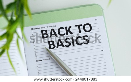 BACK TO BASICS text on notebook with pen, folder on white background