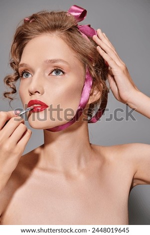 A young woman with classic beauty stands gracefully, the soft pink ribbon around her neck adding a touch of elegance.