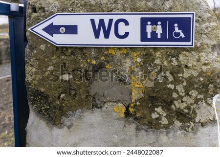 Accessible restroom sign depicting both standard and disabled WC symbols, ideal for inclusion .
