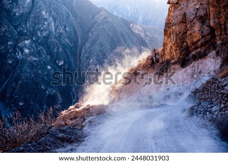 dirt roads climbs through the valleys of the Colca Canyon in the province of Arequipa in Peru between clouds of dust and landscapes of pristine valleys
