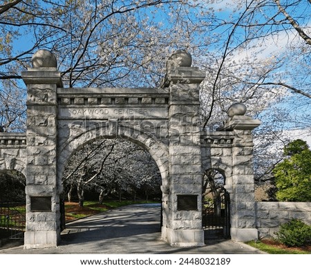 Historic Oakwood cemetery entrance and Spring trees in bloom in Raleigh North Carolina Royalty-Free Stock Photo #2448032189