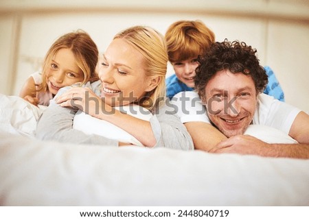 Portrait, happy and family in bed with kids, parents and play for bonding in bedroom. Couple, children and smiles for together, love and support in home on weekend for relaxing, break and happiness