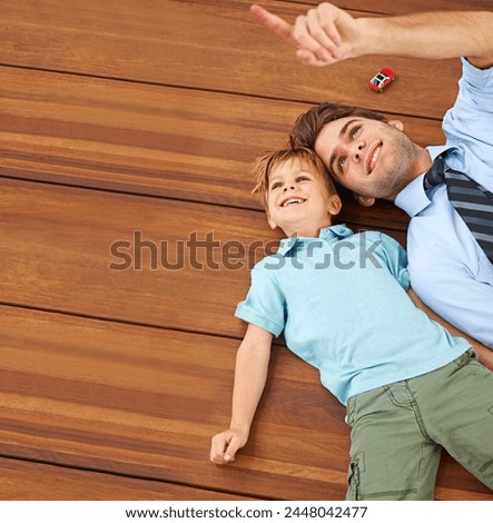 Dad, child and toy playing on floor by pointing at roof in house for fun, learning and connection. Single father, male kid and little car in home with smile for happy, child development and bonding Royalty-Free Stock Photo #2448042477