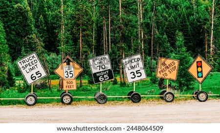 Row of lined up traffic safety signs on side of road