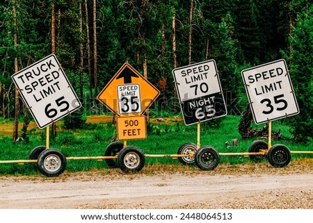 Several road construction signs lined up in a row
