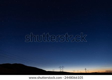 Night sky with stars at sunset with mountain silhouette