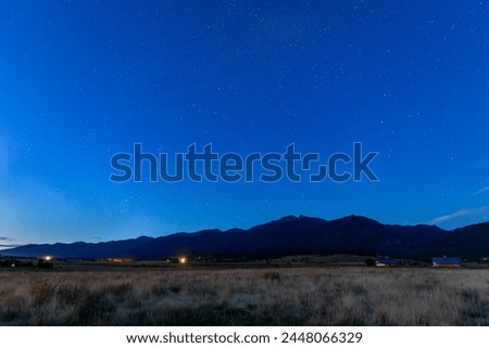 Montana night sky with stars and mountain silhouette