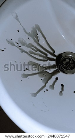 The photo shows the sink smeared with black paint.