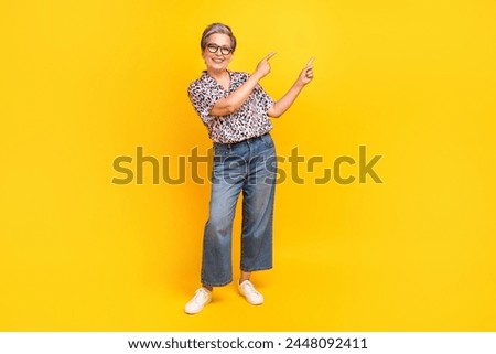 Full size photo of pretty retired female point empty space poster dressed stylish leopard print outfit isolated on yellow color background