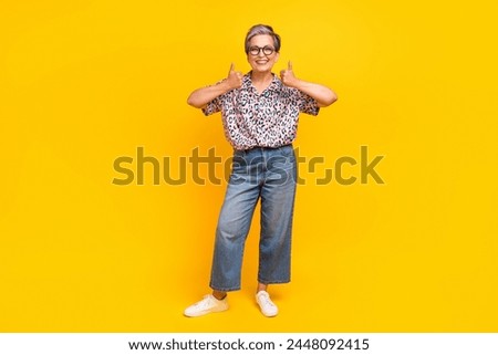 Full length photo of lovely senior lady show double thumbs up dressed stylish leopard print garment isolated on yellow color background
