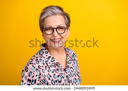Photo portrait of attractive pensioner woman look camera dressed stylish leopard print clothes isolated on yellow color background