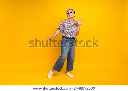 Full length photo of lovely senior lady dancing have fun summer wear trendy leopard print garment isolated on yellow color background