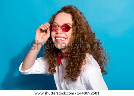 Photo portrait of nice young lady touch sunglass summer vacation wear trendy white garment isolated on blue color background