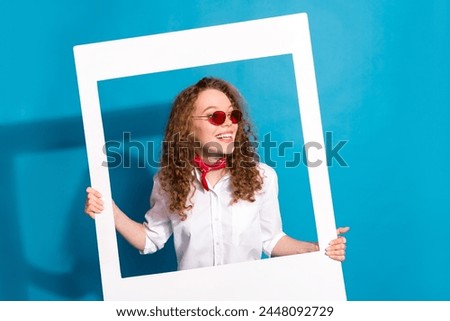 Photo portrait of nice young lady sunglass instant photo frame look empty space wear trendy white garment isolated on blue color background
