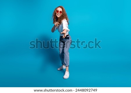 Photo portrait of nice young lady dance point you sunglass summer vacation wear trendy white garment isolated on blue color background