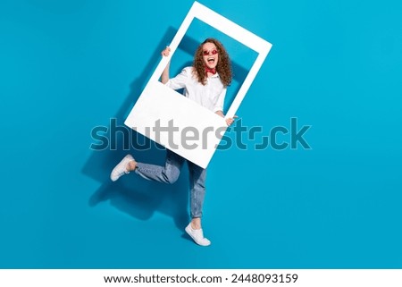 Photo portrait of nice young lady sunglass hold instant photo frame walking wear trendy white garment isolated on blue color background