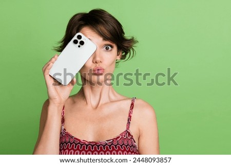Photo of lovely cute girl blogger wear trendy clothes showing modern technology brand blank space isolated on green color background