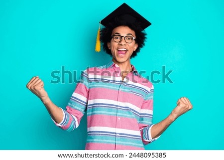 Photo of glad cheerful nice man wear stylish clothes celebrate graduation isolated on cyan color background