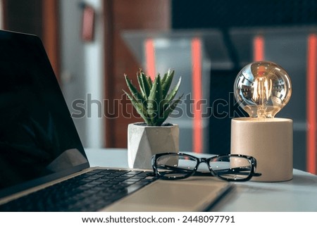 Office desk with laptop on it, glasses, decor, business concept, stock photo