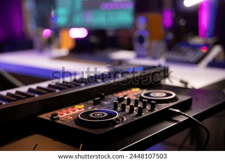 Empty home studio used for recording music on electronic acoustic tools, mixing and mastering tunes with modern equipment. Creating soundtracks with panel soundboard and performance console. Royalty-Free Stock Photo #2448107503