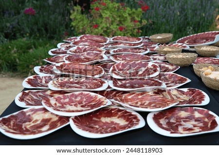 group of dishes with pieces of delicious Iberian ham. Spanish ham and traditional food. Mediterranean diet Royalty-Free Stock Photo #2448118903