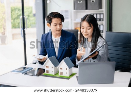 Balancing the property sector The real estate agent is explaining the house style to see the house design and the purchase agreement. model house at modern office